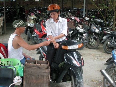 Hình ảnh bãi giữ xe truyền thống với việc soát vé thủ công